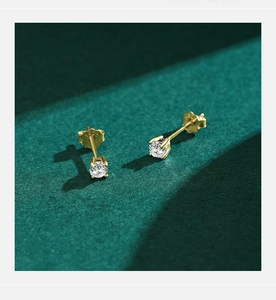 Detail of S925 sterling silver stamp on four-prong gold-plated moissanite stud earrings
