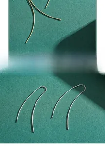 Detail of minimalist S925 sterling silver ear threaders in gold and silver finish