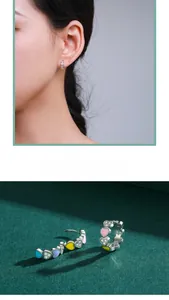 Close-up of S925 sterling silver hoop earrings with colorful enamel hearts and zircons
