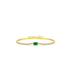 Gold tennis bracelet with rectangle emerald green gemstone and cubic zirconia accents