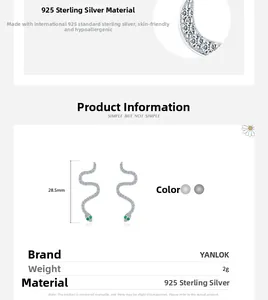 Macro view of 925 sterling silver snake earrings with white stones and green gemstone eyes
