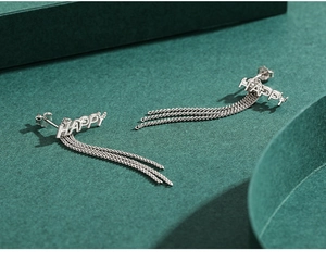 Detail of S925 sterling silver drop earrings with HAPPY letters and long chain tassels