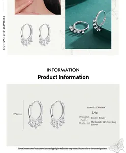 Macro detail of S925 sterling silver hoop earrings with five sparkling zircon charms