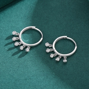 S925 sterling silver hoop earrings with five hanging cubic zirconia on dark green background