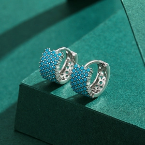S925 sterling silver huggie earrings with turquoise pavé stones on textured background