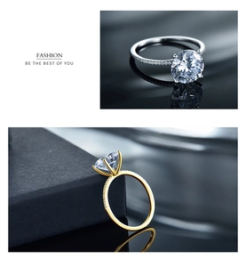 Detailed view of silver and gold rings featuring round zircon in a classic six-prong setting