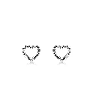 Vintage sterling silver hollow heart stud earrings with black dotted texture on white background