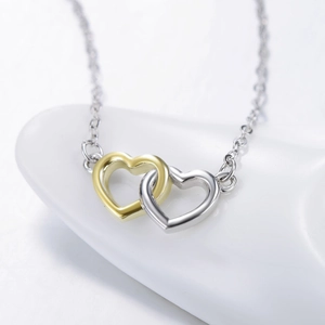 Exquisite S925 sterling silver interlocking heart necklace with two-tone finish detail