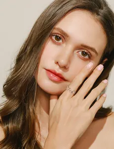 Close-up of interlocking silver ring on a model hand with a minimalist aesthetic style