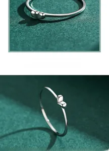 Macro detail of 925 sterling silver ring featuring a polished heart shape decoration
