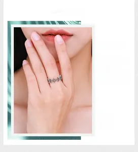Close-up of vintage 925 silver hollow geometric ring with sparkling pavé zircons