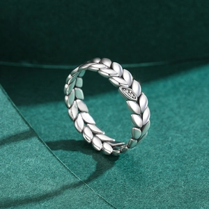 Vintage 925 sterling silver leaf ring with three sparkling crystals on dark background
