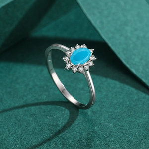 925 sterling silver ring with oval turquoise and pavé cubic zirconia on green background
