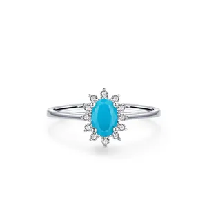 925 silver ring featuring an oval turquoise stone surrounded by zircons on white background