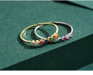 Close-up of gold and silver 925 sterling silver rings with rainbow gemstones