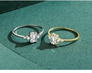 Macro shot of silver and gold rings with rectangular crystal and side pavé stones