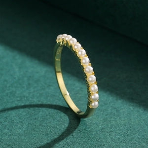Elegant 925 sterling silver gold plated ring featuring eleven round white pearls in a row