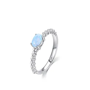Elegant 925 sterling silver ring featuring a blue oval opal and beaded bubble band design