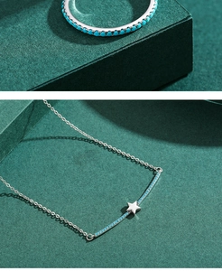 Macro shot of silver S925 ring and star necklace set with turquoise blue gemstones
