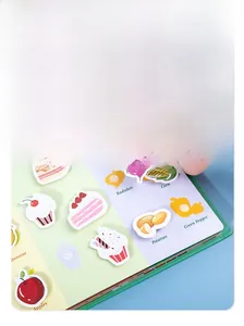 Close-up of hand matching radish stickers in a colorful Montessori quiet busy book