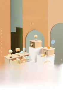 Detail view of Montessori wooden object permanence box and spinning drum for toddlers