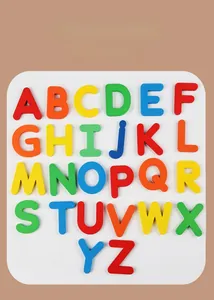Macro detail of 26 colorful wooden capital letters in a white tray for spelling practice