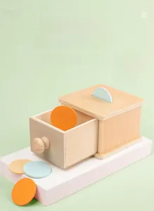 Detail view of Montessori wooden drawer box with colorful coins for early childhood learning