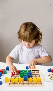 Close-up of a child playing with colorful geometric wooden blocks on a grid base