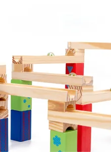 Detail of colorful wooden marble run blocks with smooth edges and glass marbles