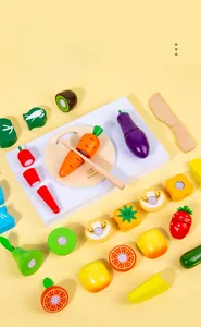 Detail of wooden play food set with colorful fruits and vegetables on a mini cutting board
