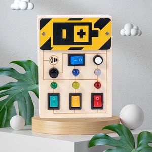 Detail of wooden sensory busy board with colorful LED light switches and button controls