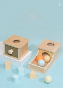 Detail of Montessori wooden object permanence box with colorful geometric blocks and ball