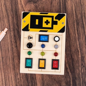 Detail of wooden busy board toy featuring colorful LED switches and sensory buttons