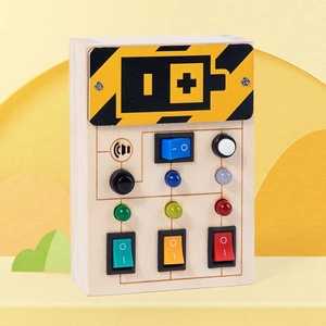 Close-up of wooden busy board with colorful LED lights and various toggle switches