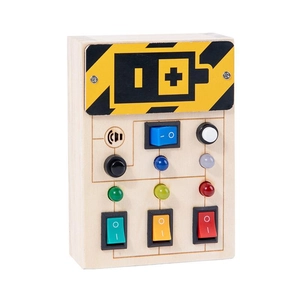 Macro detail of wooden busy board toy featuring colorful LED lights and rocker switches