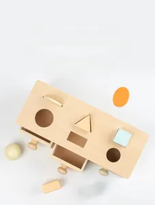 Detail showing Montessori wooden shape matching box with colorful blocks and three drawers