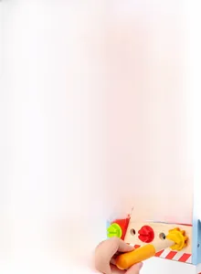 Close-up of wooden toy toolbox with realistic hammer, screws, and colorful gears