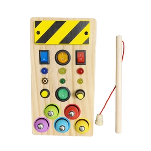 Macro shot of wooden sensory busy board featuring colorful LED lights and toggle switches
