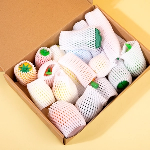 Wooden play food set with colorful fruits and vegetables in a cardboard storage box