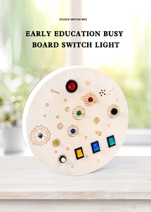 Close-up of wooden Montessori busy board featuring space theme and colorful LED switches