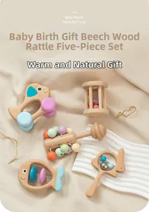 Macro detail of beech wood baby rattles set in Morandi colors on a soft fabric background