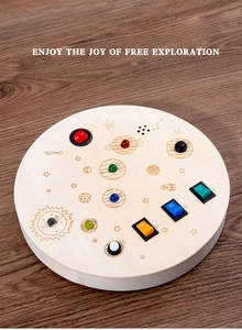 Macro detail of wooden busy board featuring colorful LED lights and power switches
