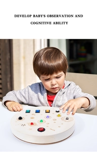 Toddler hand operating space theme wooden busy board with LED lights and toggle switches