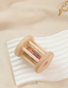 Macro detail of natural wood rolling rattle with colorful bells for infant hearing
