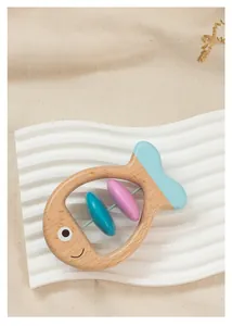 Detailed view of a fish-shaped wooden baby rattle with blue paint and rotating colorful beads