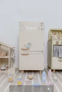 Close-up of Nordic wooden toy fridge with play food accessories on a striped rug