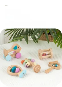 Close-up of five wooden baby rattles in macaron colors for sensory and motor skills development