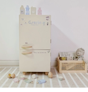 Detail of wooden play kitchen fridge with assorted toy ice cream and pretend food