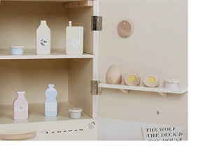 Macro detail of Nordic wooden toy fridge with realistic miniature food accessories