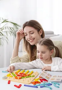 Close-up of mother and daughter playing with colorful wooden geometric pegboard puzzle